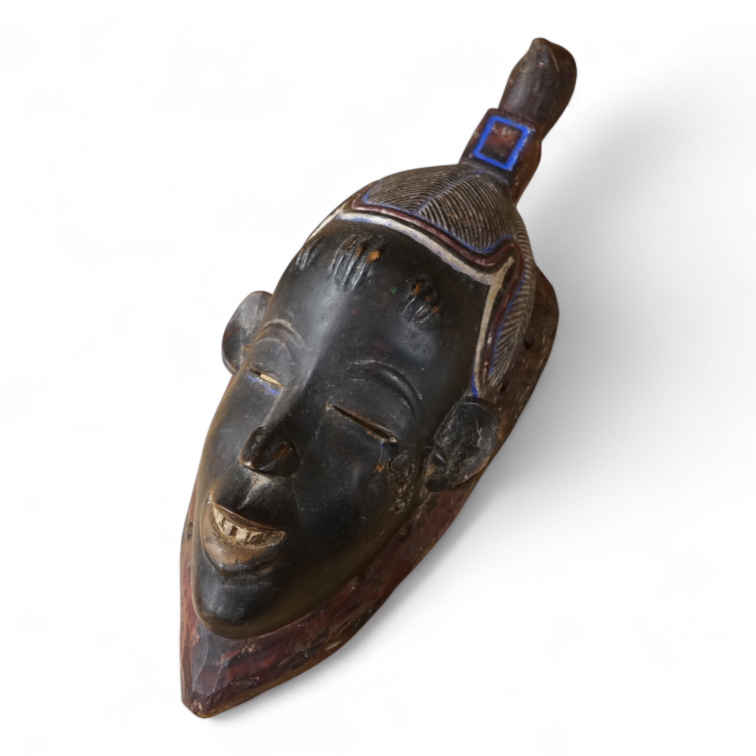 A carved African Ivory Coast mask, 39cm high